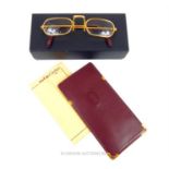 A pair of 1990s Cartier demi-lune glasses, with original Cartier leather slipcase and lens cloth;