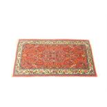 A Hamadan prayer rug, with floral designs on a red field