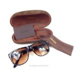 A pair of unused, Tom Ford, designer sunglasses in original Tom Ford brown suede case