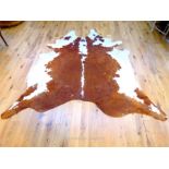 A very large, cow hide with mottled brown and white colouring