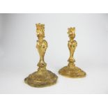 A pair of ornate gilt metal candlesticks; each 23cm high.