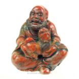 A finely-carved , Chinese, red soapstone figure of a seated gentleman