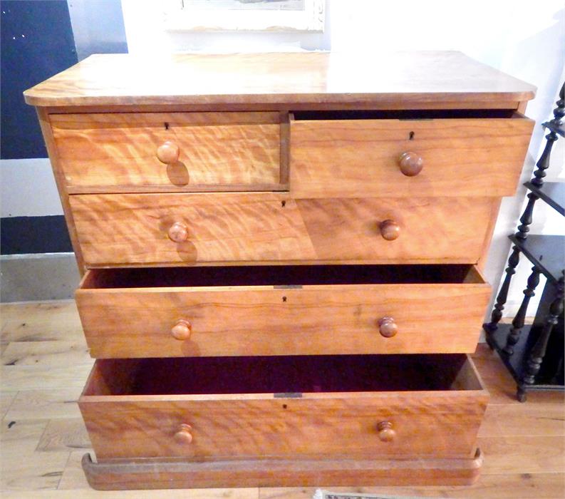 A Victorian satinwood chest of two long over three long graduated drawers