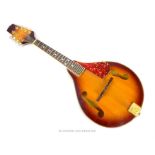 A mandolin with a sunburst finish and 'F' holes