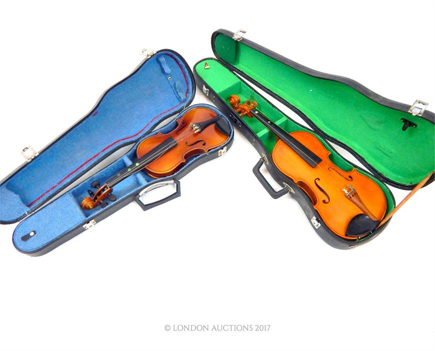 Two student's violins in hard cases