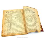 A brown leather bound Persian book, dated to 1910