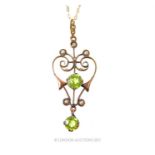 An Edwardian 9ct rose gold pendant, with claw set peridots and seed pearls