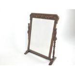 An early 20th century, hand-carved, swing-framed dressing table mirror