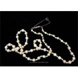 An antique, natural, pearl strand necklace with a gold and rose-cut diamond clasp