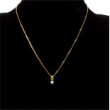 An 18 ct yellow gold diamond solitaire pendant on 9 ct yellow gold chain