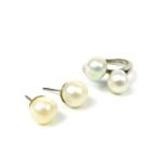 A solid 18 ct, white gold ring composed of two large, Baroque pearls with matching stud earrings