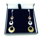 A pair of 9 ct white gold, contemporary, drop earrings with yellow and rose gold discs