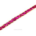 A fine, natural, ruby tennis bracelet (Tested as 14 ct yellow gold)