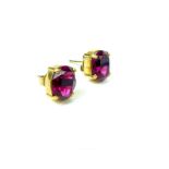 A pair of 9 ct yellow gold, stud earrings set with pigeon's blood-coloured Swarovski crystals