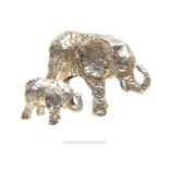 A graduated pair of African sterling silver elephants, in the manner of Patrick Mavros