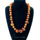 An antique, hand-faceted, large, amber bead necklace