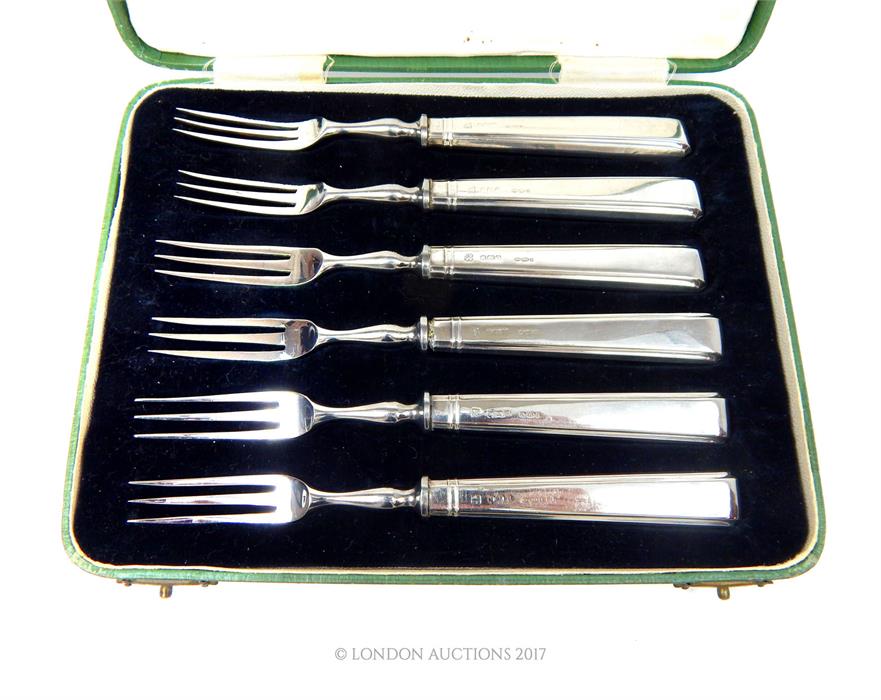 A cased set of six sterling silver handled dessert forks