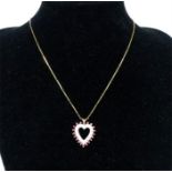 A large, yellow gold, diamond and ruby, heart-shaped pendant and chain