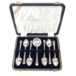 A cased set of six sterling silver teaspoons with the matching sugar spoon