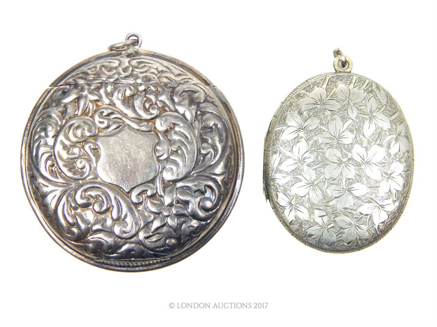 An early 20th century silver plated oval locket together with an Edwardian vesta case