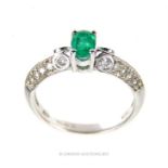 An 18 ct white gold, emerald and diamond ring