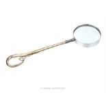A magnifying glass with a sterling silver handle