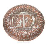 A circular copper dish, inlaid with silver