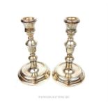 A pair of sterling silver candlesticks, HBH, Birmingham 2000, having Millennium mark