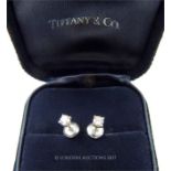 A cased and boxed, pair of elegant, Tiffany and Co, platinum and diamond stud earrings