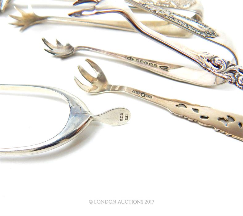 A pair of sterling silver wishbone sugar nips, with one silver and three plated examples - Image 2 of 2