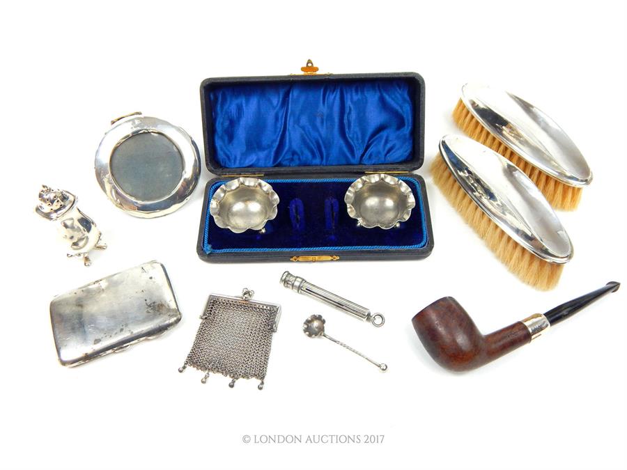 A collection of sterling silver items, including a cigarette case