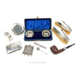 A collection of sterling silver items, including a cigarette case