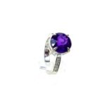 A chunky, 18 ct white gold, diamond and large amethyst ring