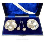 A cased pair of Victorian sterling silver salts with matching spoons