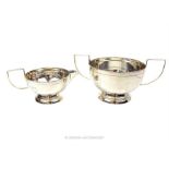 A matching sterling silver sugar bowl and milk jug