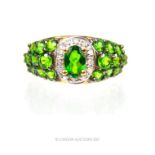 A 9 ct yellow gold, diamond and grossular (green) garnet dress ring