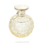 A cut glass and sterling silver perfume bottle