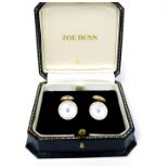 A boxed pair of 14 ct yellow gold, cuff-links set with a diamond, mother of pearl and white enamel