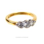 An 18 ct yellow gold, three stone, diamond ring