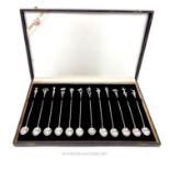 A cased set of twelve .833 standard solid silver long cocktail spoons