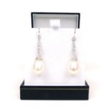 A pair of spectacular, 18 ct white gold, pearl and diamond drop earrings