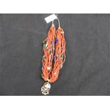 A multi-strand, coral necklace