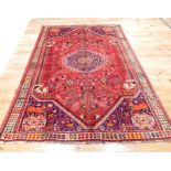 A fine Southwest Persian Qashqai carpet, having a medallion on a red field with spandrels,