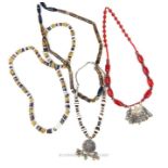 Four Bedouin coloured glass and metal bead necklaces, including two metal pendents; necklaces of