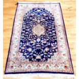 A Kashmir rug, having a medallion on a midnight blue field