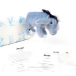 A Steiff soft toy Eeyore with articulated limbs and original box.