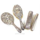 A late 19th century silver backed and highly decorative dressing table brush and a mirror
