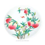 A Chinese famille rose charger, hand painted with peaches