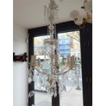 A large white painted metal eight branch chandelier