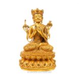 A gilt bronze Buddha figure, seated upon a lotus base